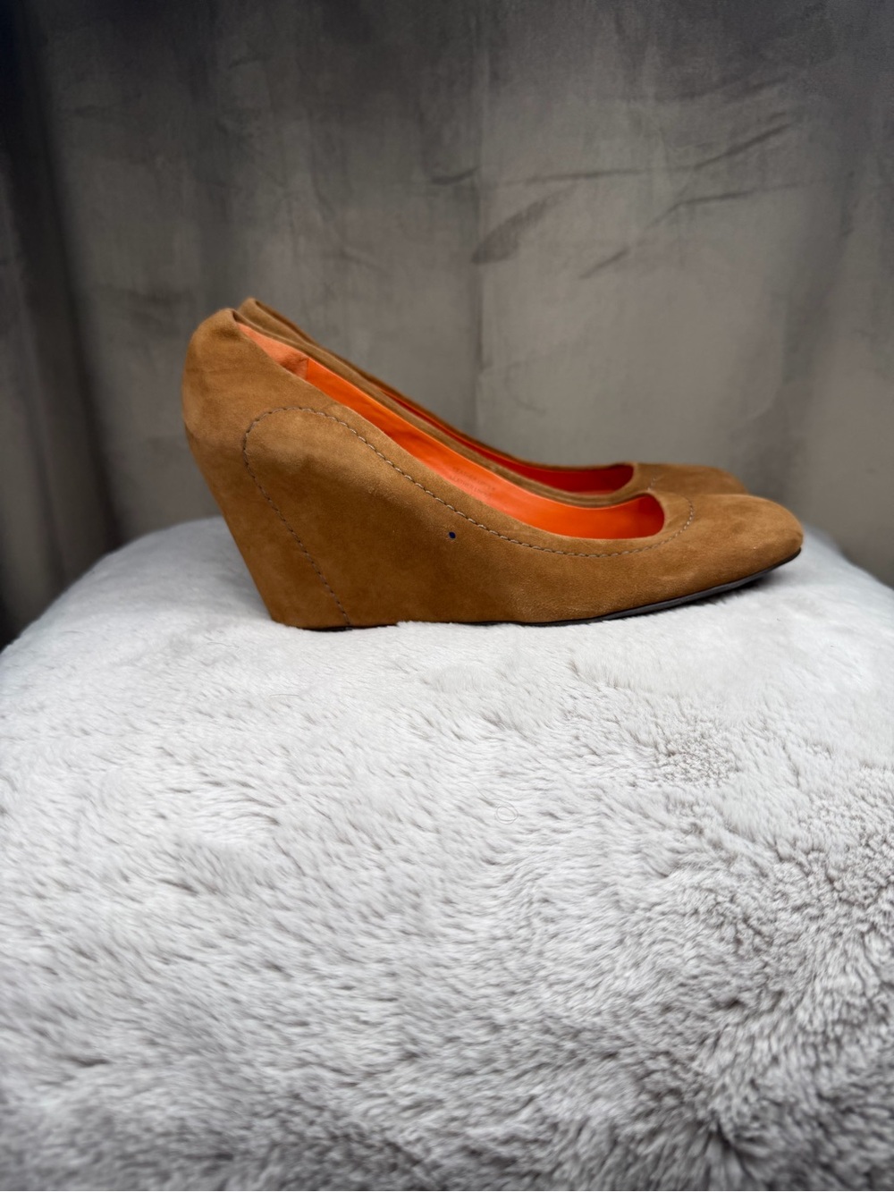 brown suede pumps by Via Spiga featuring a bright orange interior lining.